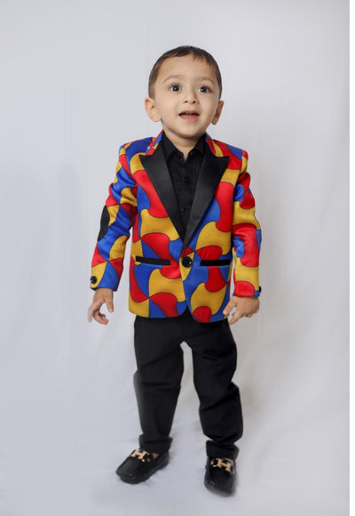 a young boy dressed in a colorful suit